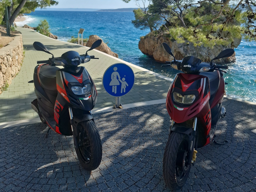 A red Tomos moped